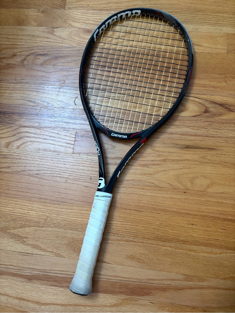 Gamma Tennis Racquet in Black with Red Accents and White Grip